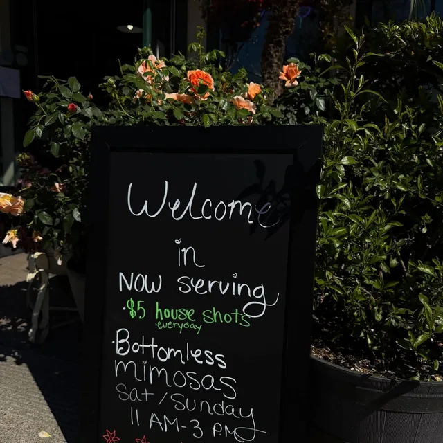 The welcome chalkboard: $5 house shots every day and weekend bottomless mimosas